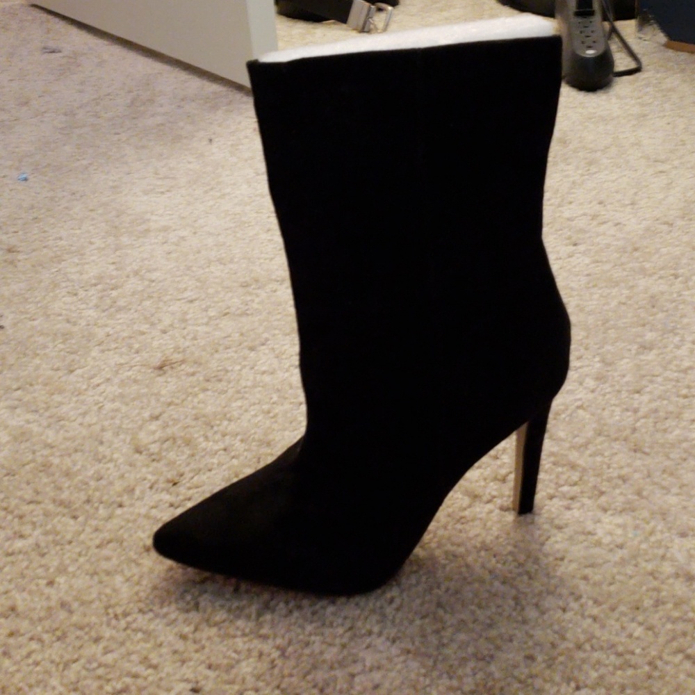 High heel boots. Never worn. Too small
